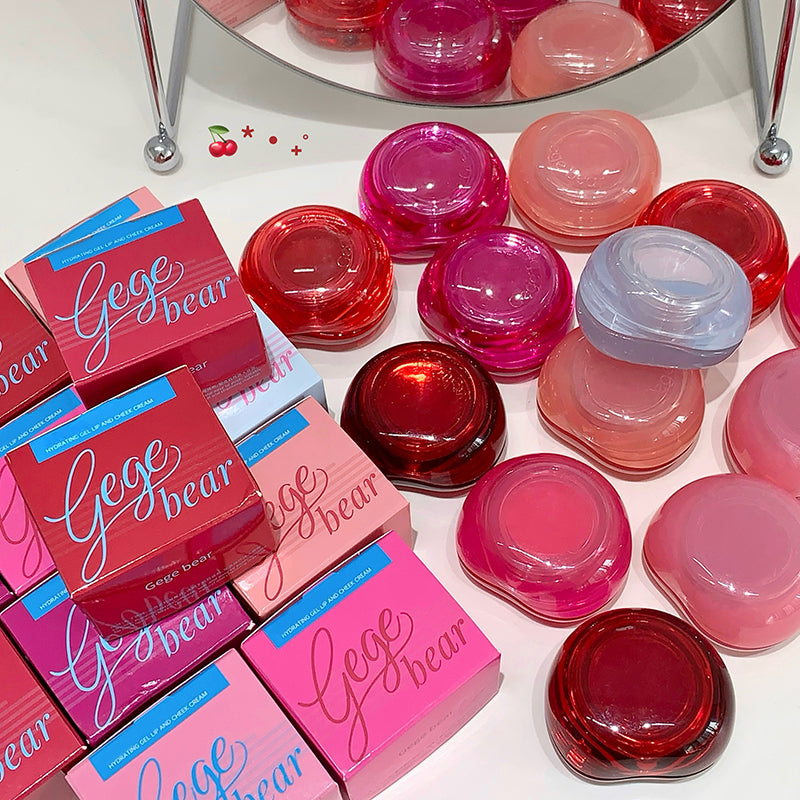 Gege bear lip balm containers and boxes on a white surface