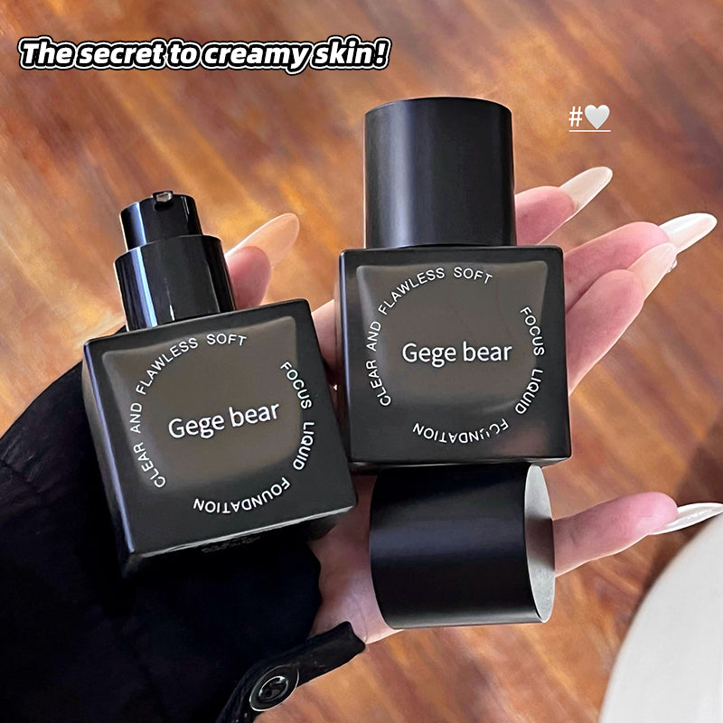 Two black Gege bear skincare products held by a hand on a wooden surface.