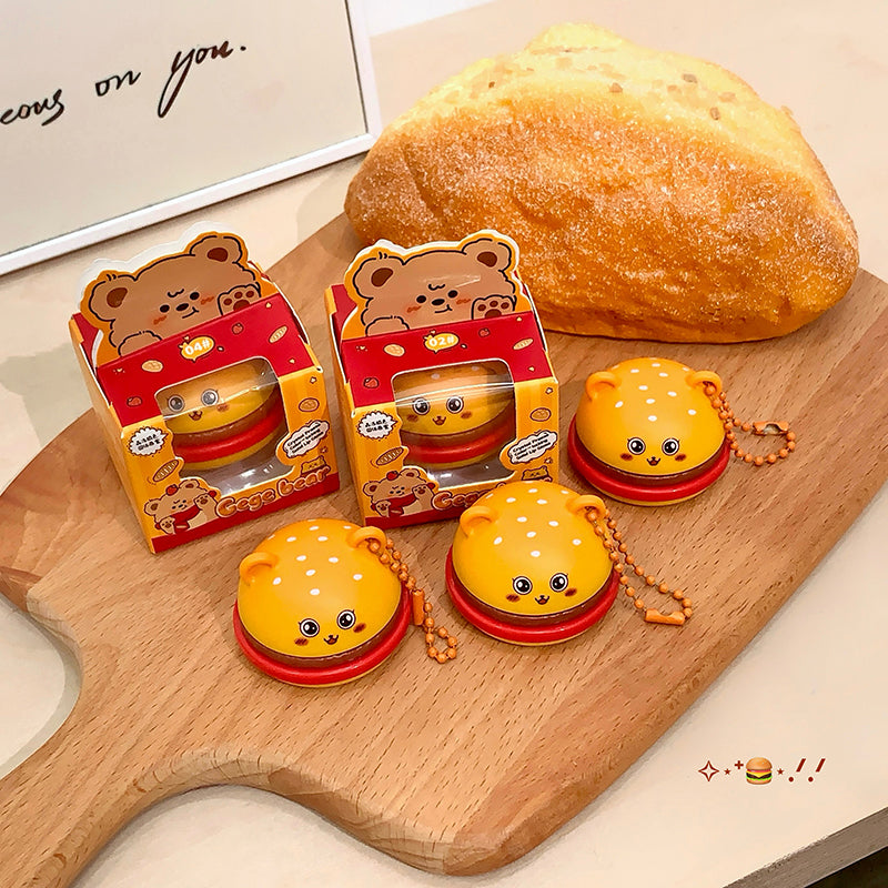 Cute bear-shaped rubber bands with packaging on a wooden board with bread in the background.