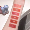 Lipstick swatches on a person's arm with numbered labels, next to small bear-shaped containers.