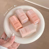 Five pink bottles with 'Gege bear' branding on a white plate.