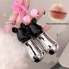 Black and silver lip-shaped product held by a hand with a pink strap.