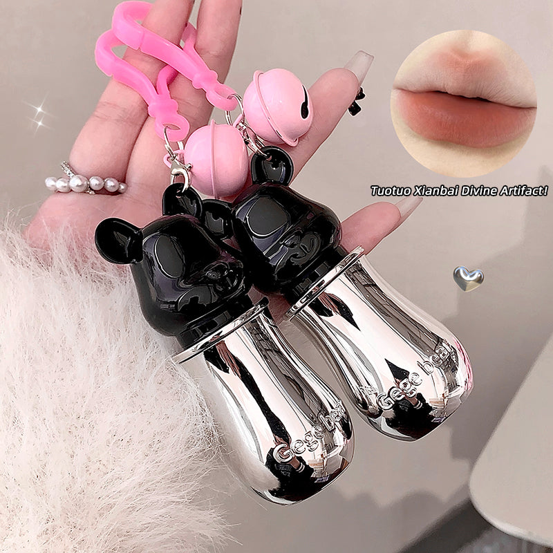 Black and silver lip-shaped product held by a hand with a pink strap.