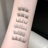 Set of false eyelashes displayed on a person's arm against a neutral background
