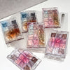 Set of nail polish sample packets on a white background