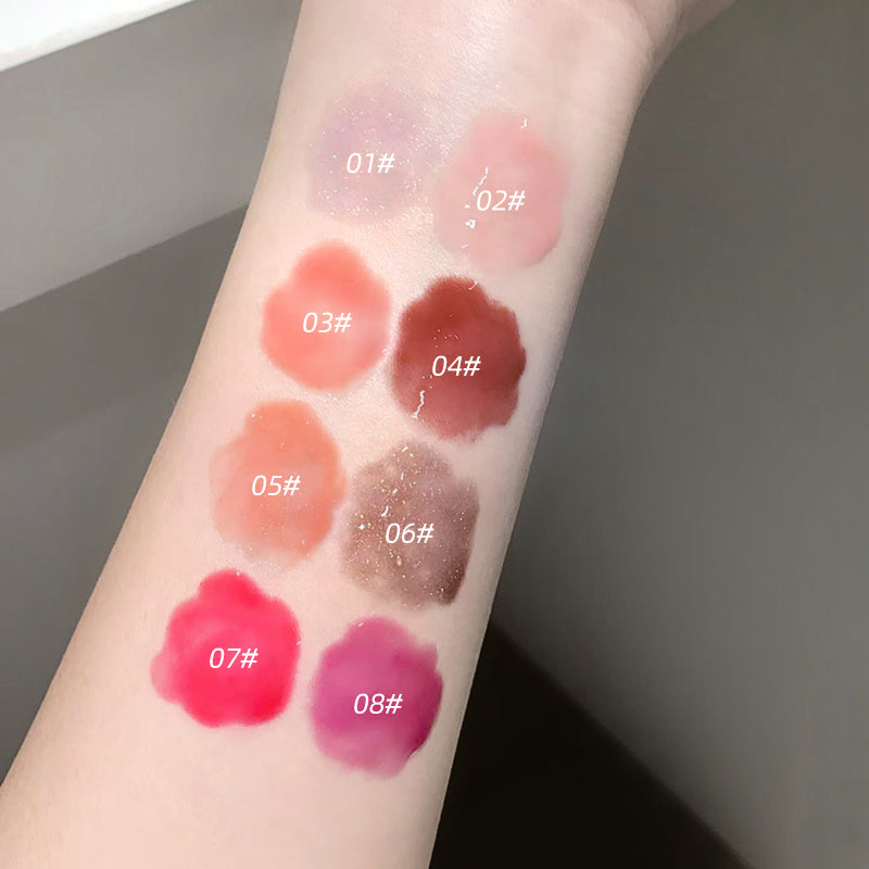 Lipstick swatches on a person's arm with labeled colors