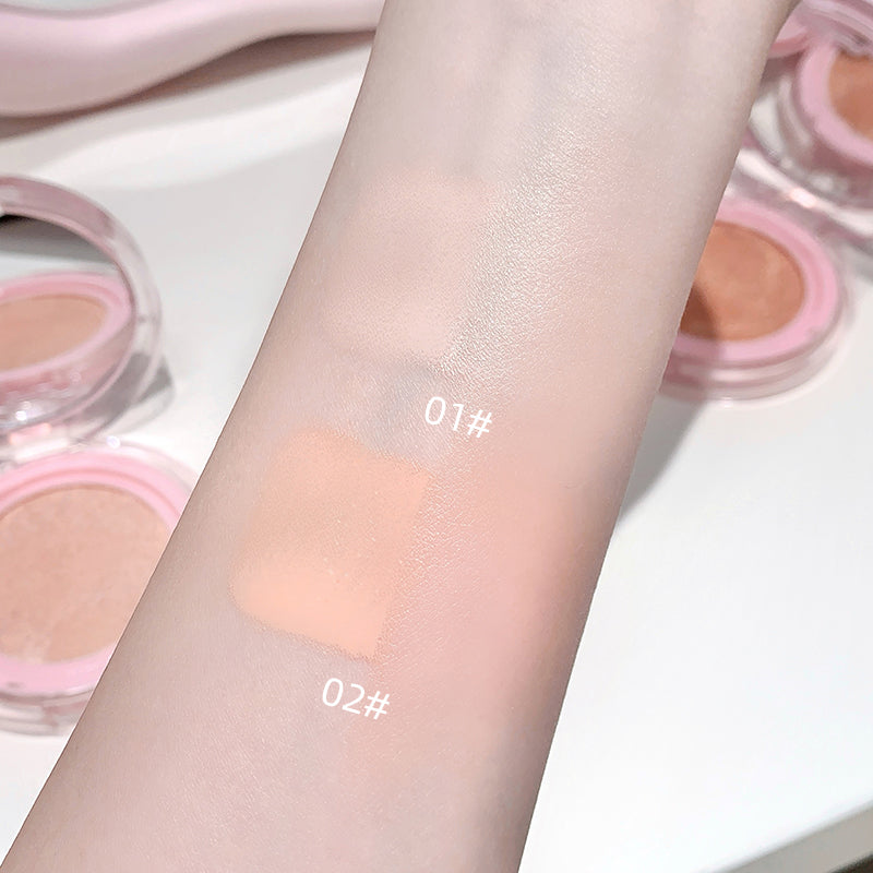 Cosmetic product swatches on a arm with '01 Ivory White' and '02 Natural Color' labels.