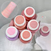 Set of pink and purple cosmetic sponges with close-up of texture on a white surface.