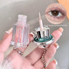 Clear nail polish bottle with a chain and close-up of a glittery eye color.