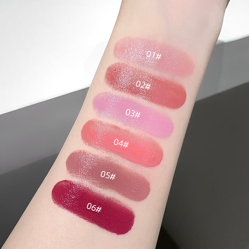 Lipstick swatches on a person's arm with color labels