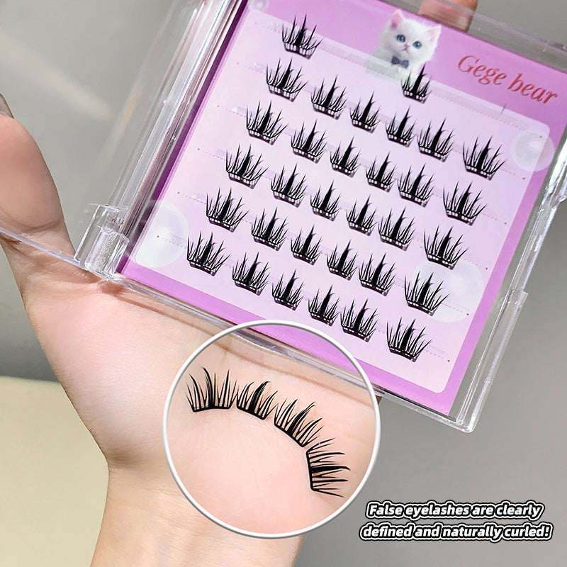 False eyelashes in a clear case with a pink label, held by a hand.