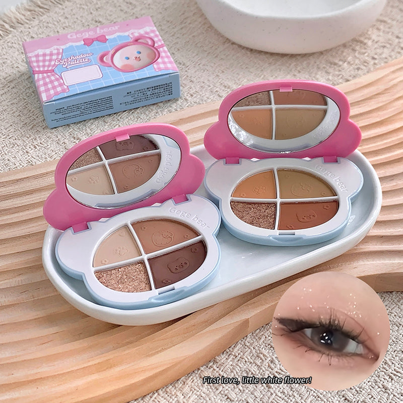 Makeup palette with mirrors and eyeshadow shades on a wooden surface, with a close-up of an eye wearing makeup.