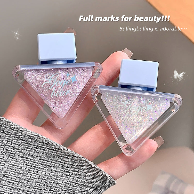 Triangular glittery lip gloss held in a hand with text 'Full marks for beauty!!! Bullingbulling is adorable...'.