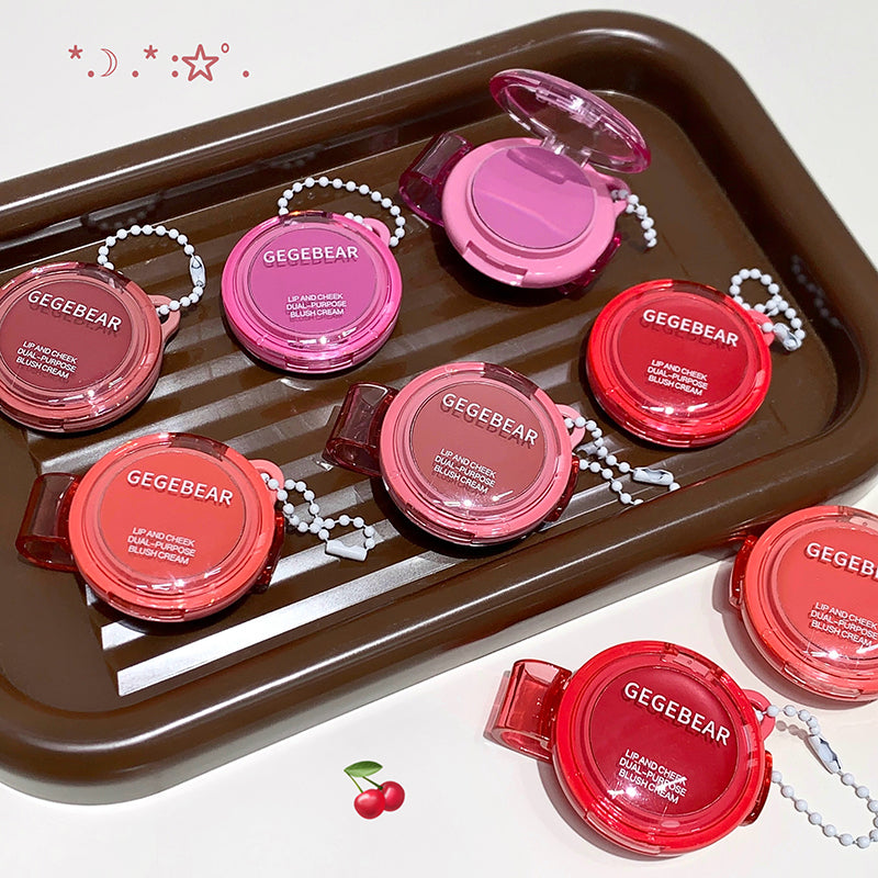 Set of GEGBEAR lip products on a brown tray with cherry graphics.