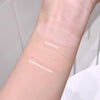 Two swatches of cream on a person's arm labeled '01#Ivory' and '02#Natural color'.