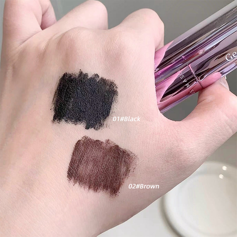 Makeup pencil with black and brown swatches on a hand, brand 'Ge' visible