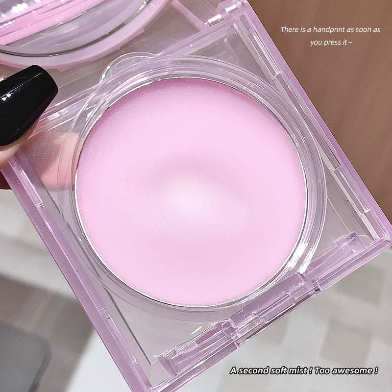 Pink makeup compact with a handprint on a neutral background