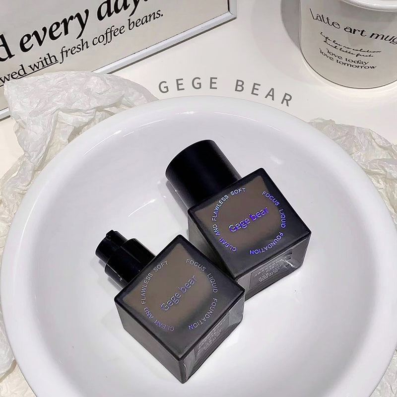 Two black perfume bottles with 'GEGE BEAR' branding on a white plate.