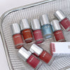 Gege bear nail polishes in various colors on a metal grid background