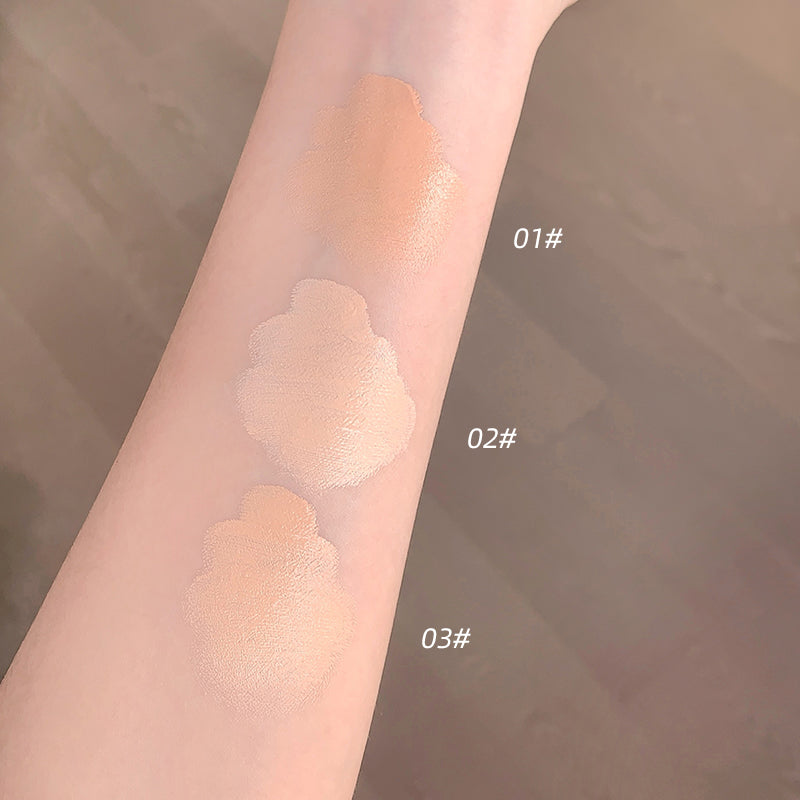Three swatches of a cosmetic product on a person's arm with color codes 01#, 02#, and 03#. The background is blurred.