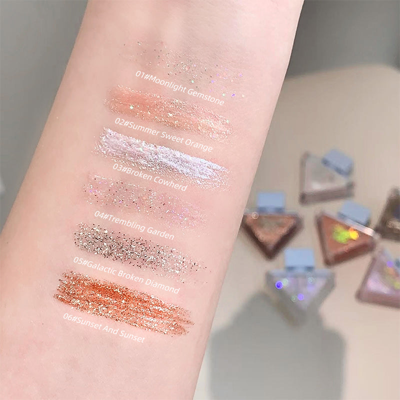Color swatches on a person's arm with glittery finishes, showing different shades.