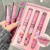 Set of pink lip products with cartoon designs in a box, held by a hand.