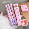 Pink and purple makeup products with a bear design on a wooden surface.