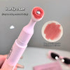 Lip cream applicator with red applicator head and white handle, showing lip color swatch on gray background.