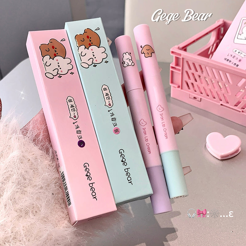 Two lip cream products with their packaging on a light surface, featuring the brand 'Gege Bear'.