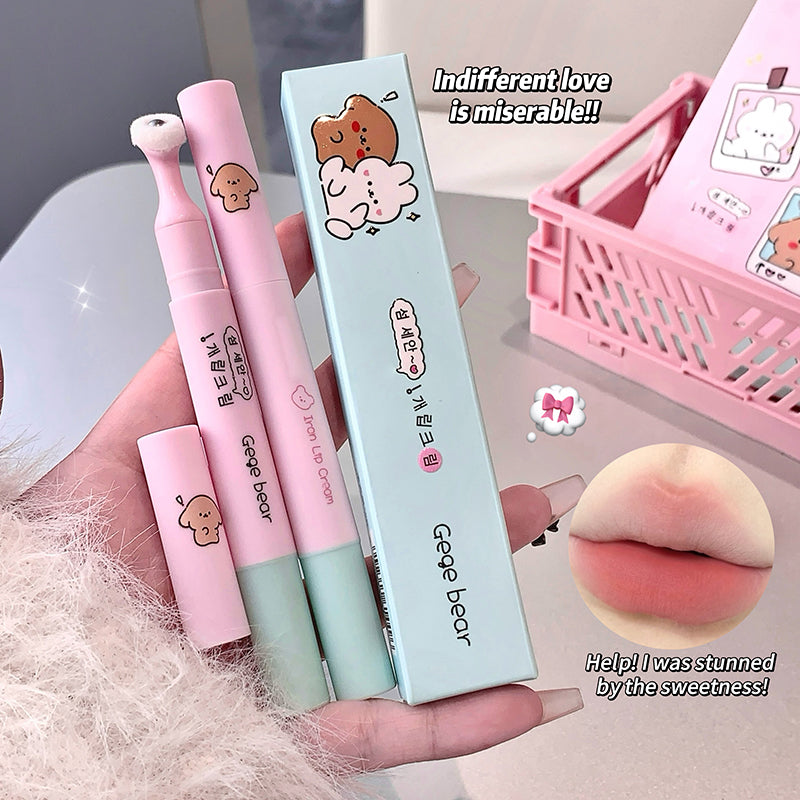 Set of pink and green lip products with a cute packaging design, held by a hand.