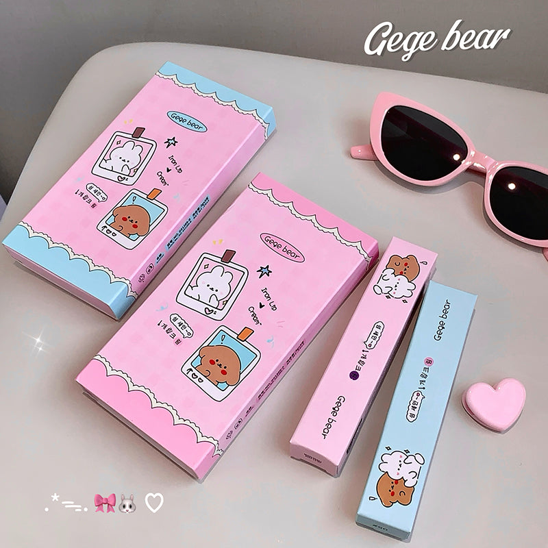 Pink cosmetic boxes with cartoon characters and sunglasses on a light surface, featuring the brand 'Gege bear'.