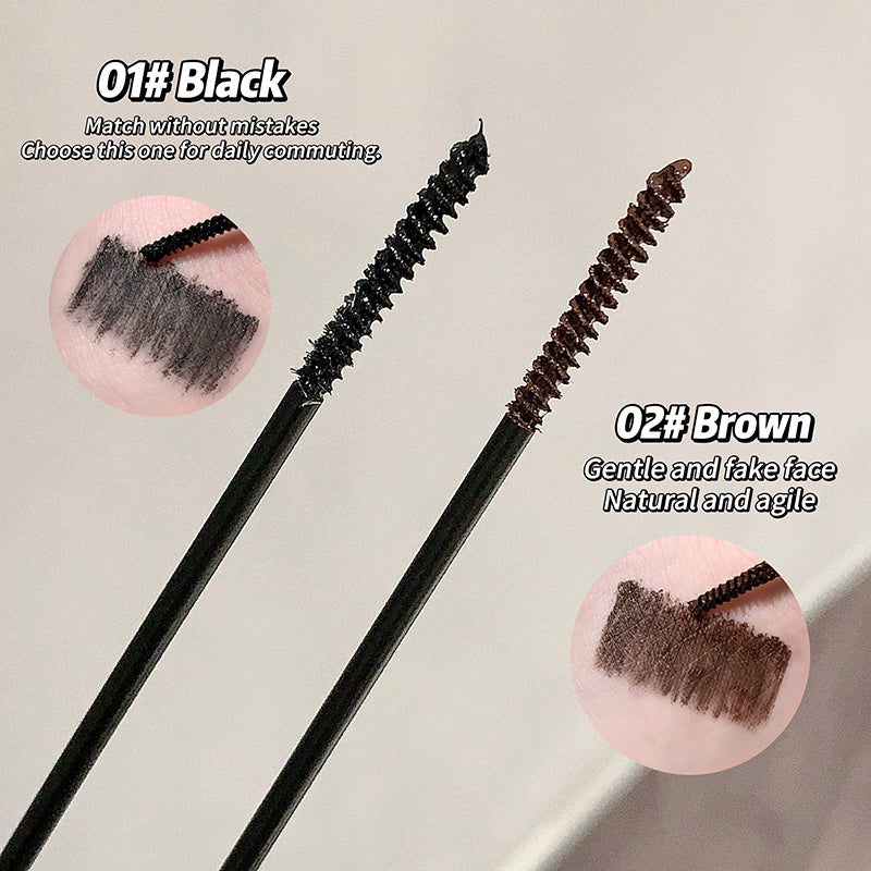 Two mascara brushes with black and brown bristles on a light gray background.