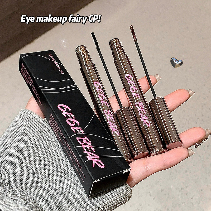 Two GEGE BEAR mascara tubes held by a hand with a black box in the background.