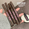 Five GEGE BEAR mascara tubes held by a hand with a blurred background