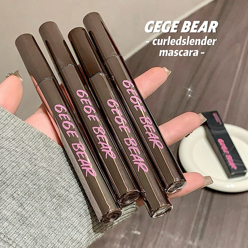 Five GEGE BEAR mascara tubes held by a hand with a blurred background