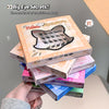 Stack of false eyelash boxes with colorful packaging held by a hand.