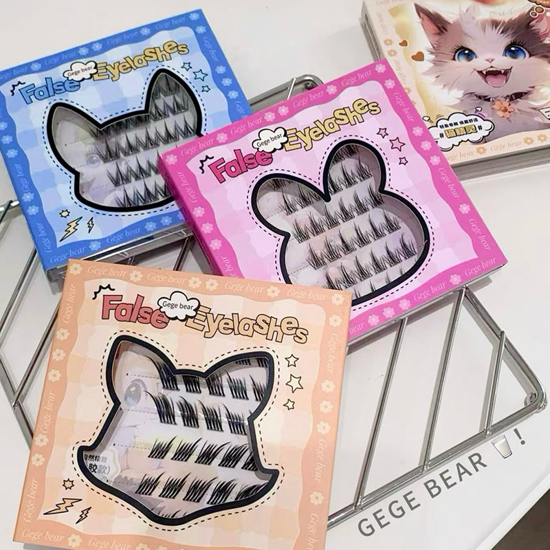 Three packages of false eyelashes with colorful packaging on a white surface.