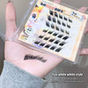 False eyelashes in a box held by a person with an example on their wrist.