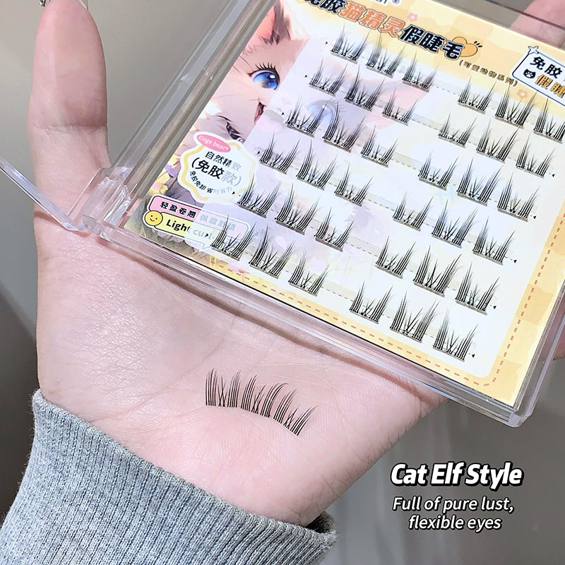 Cat elf style false eyelashes on a hand with packaging in the background