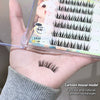 False eyelashes displayed on a hand with packaging in the background