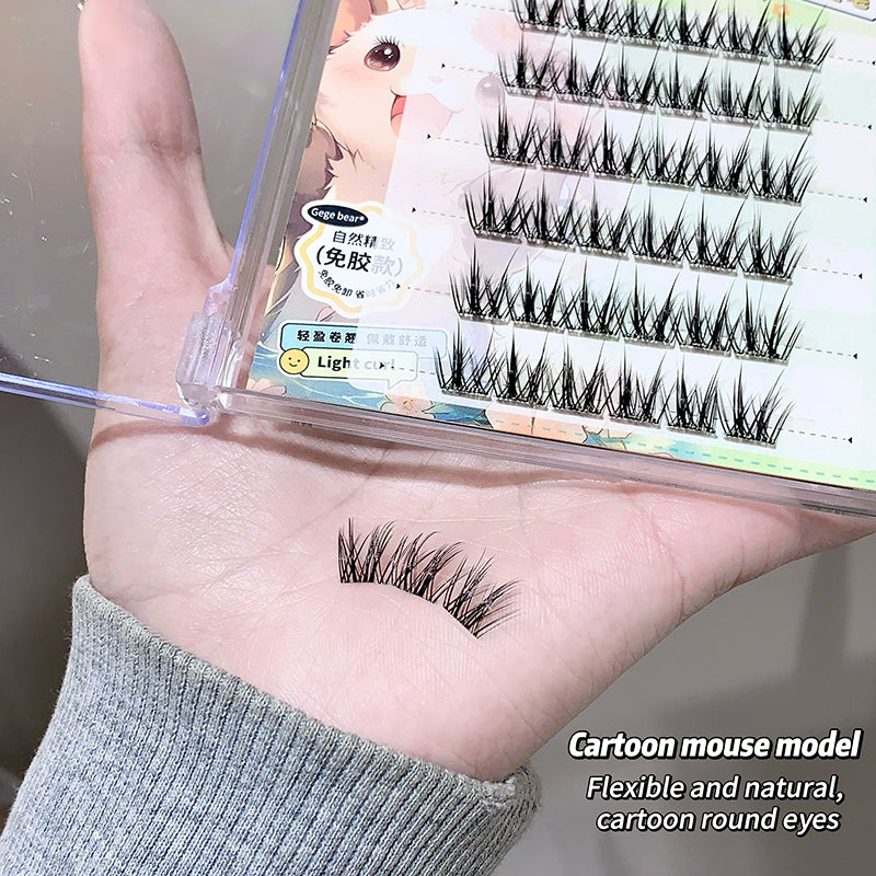 False eyelashes displayed on a hand with packaging in the background