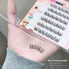 False eyelashes displayed on a hand with packaging in the background