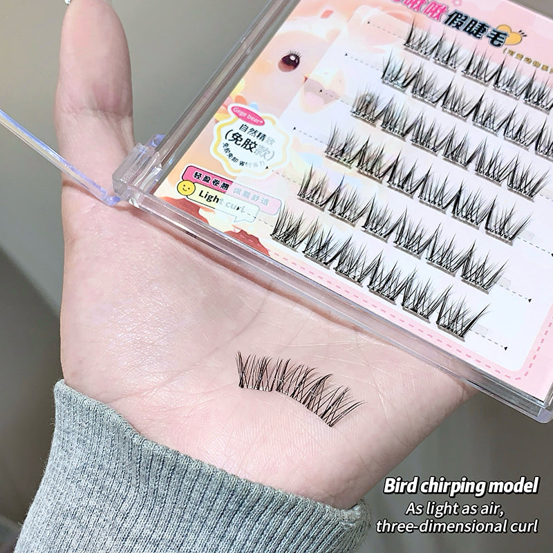 False eyelashes displayed on a hand with packaging in the background