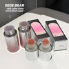 Makeup products including bottles and a brush with 'GEGE BEAR' branding on a white surface.