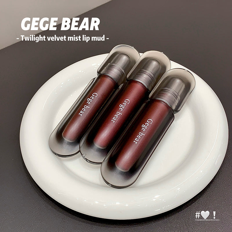 Three GEGE BEAR lip mud products on a white plate with a dark background