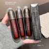 Three Gege bear lip glosses with their packaging held in a hand.