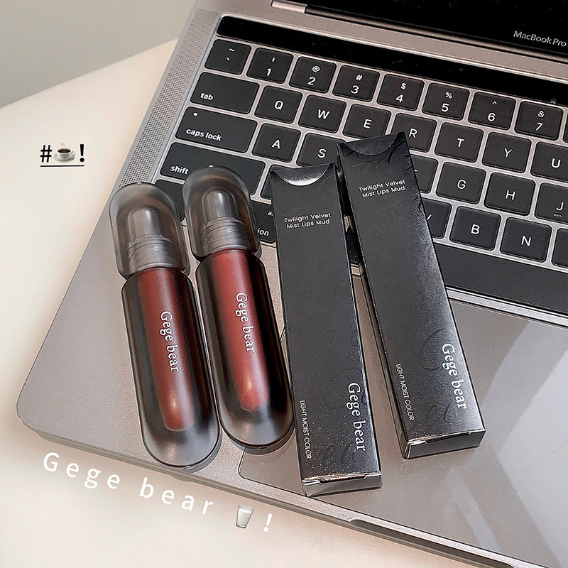 Two red lipsticks and their packaging on a laptop keyboard with 'Gege bear' branding.
