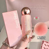 Pink cosmetic product with 'Gege bear' branding held by a hand, with a pink makeup bag in the background.