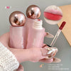 Pink lip gloss with gold cap held by a hand, close-up of lip gloss on lips, and product name 'Age Bear' displayed.