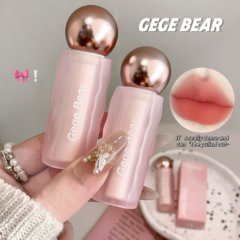 Two pink lip products with rose gold caps held by a hand, labeled 'GEGE BEAR'.
